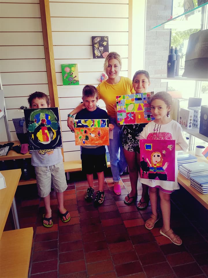 A few of the art students showing off their masterpieces with their proud teacher, Arevik, in the middle.