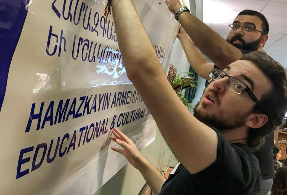 Participants from Montreal and Detroit set up the Hamazkayin banner at ArtLinks 2018. (Photo: Matthew Karanian)