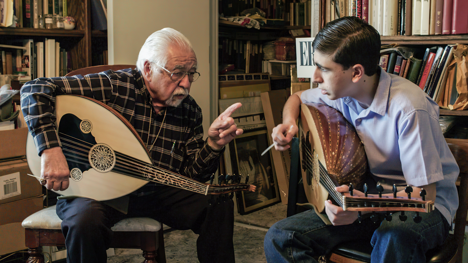 Famous oud player Richard Hagopian teaches his grandson, Andrew how to play an Armenian folk song (Photo courtesy of Stephanie Ayanian)